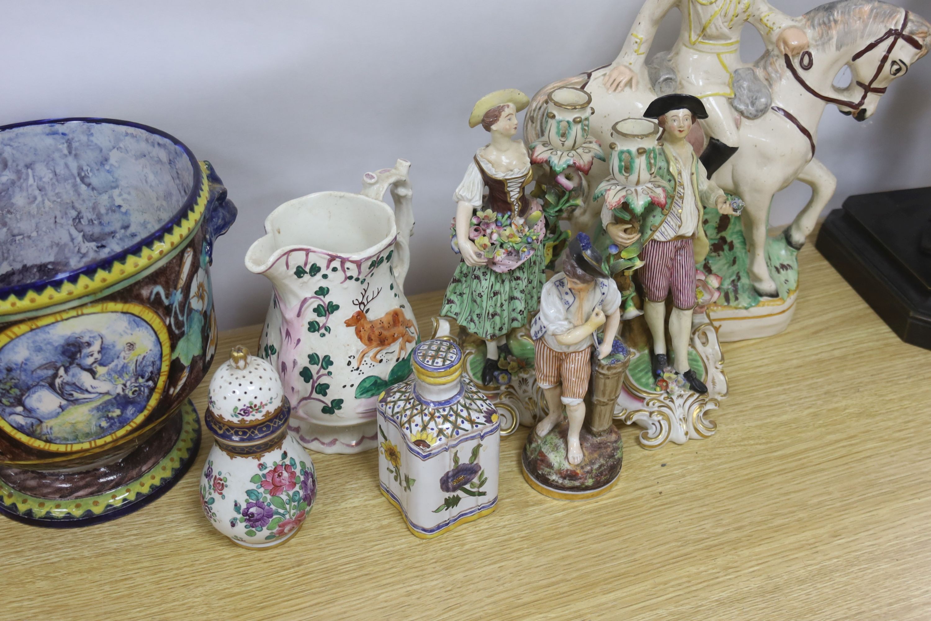 A pair of Derby candlestick figures, c.1775, 23.5 cm, a 19th century faience jardiniere or wine cooler, a Staffordshire group ‘Wolseley’ and other ceramics